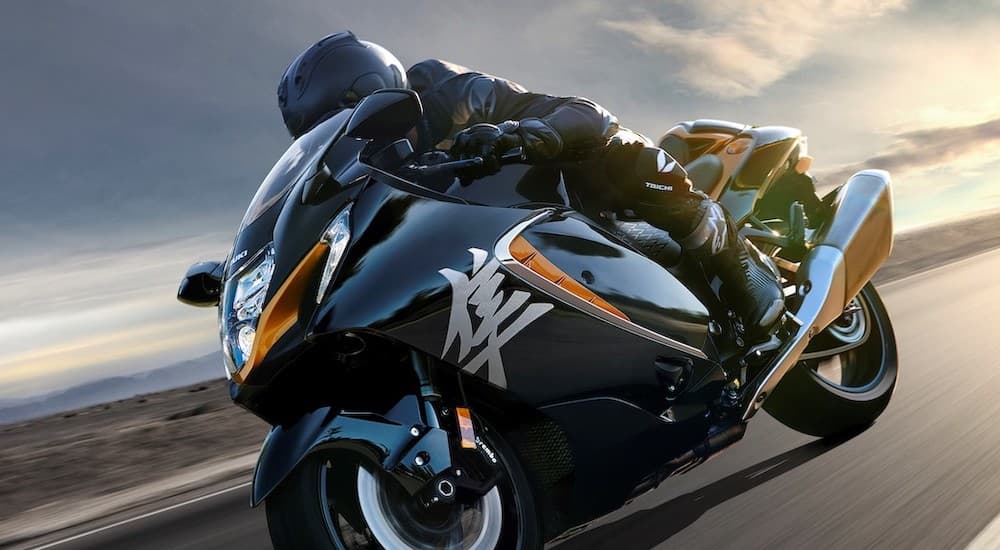 A black 2022 Suzuki Hayabusa is shown from the side while driving.