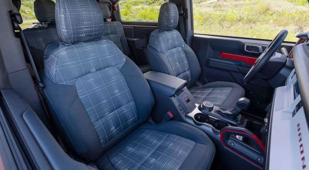 The plaid interior of a 2023 Ford Bronco Heritage Edition shows the front seating.