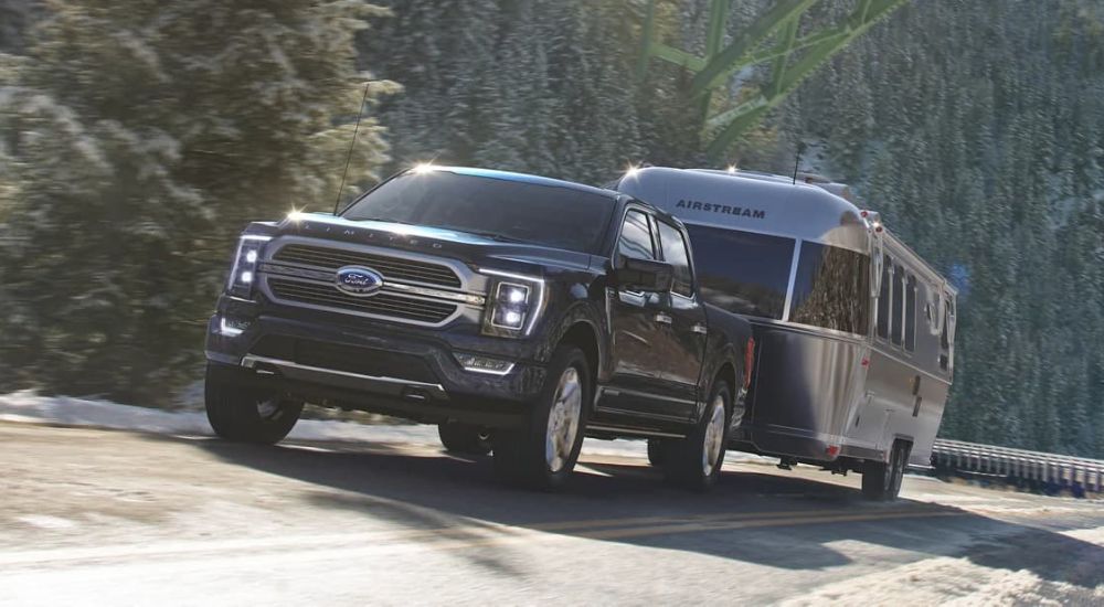 In this open topic, we look at a black 2023 Ford F-150 for sale is shown towing a silver Airstream camper.