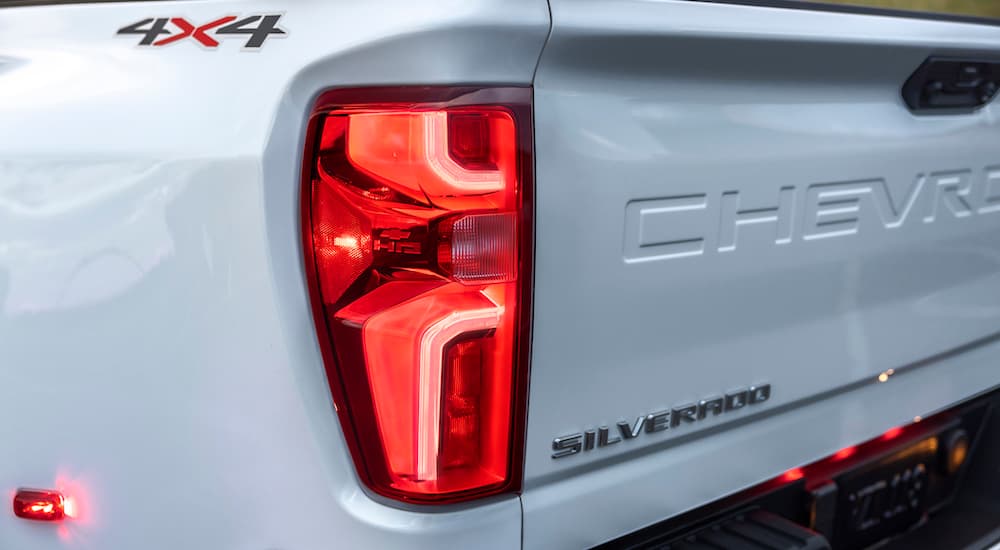 A close up shows the driver side taillight on a white 2024 Chevy Silverado 3500HD LTZ.