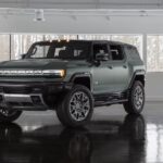 A green 2024 GMC Hummer EV is shown from the front at an angle after leaving a GMC dealer.