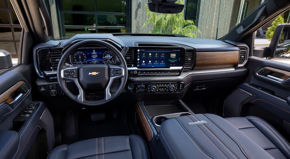 The black interior of a 2024 Chevy Silverado High Country is shown from the drivers seat.