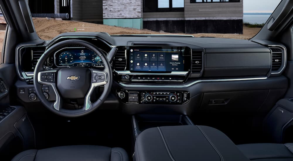 The black interior of a 2024 Chevy Silverado 3500HD LTZ is shown from the drivers seat after leaving a dealer that has a Chevy Silverado for sale.