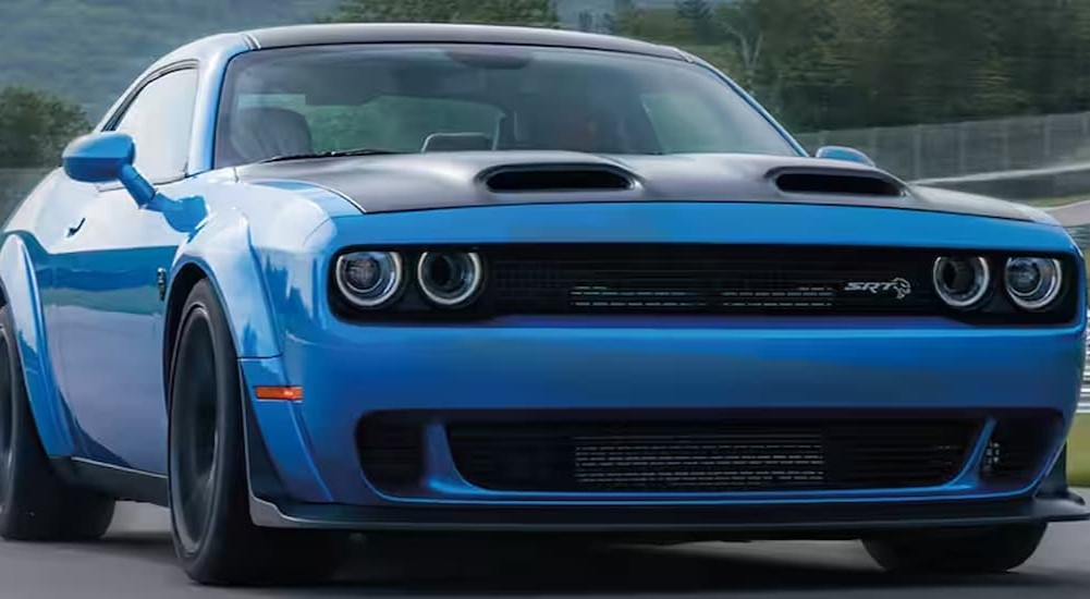 One of the 8 super awesome police cars we cant help but love, a blue 2023 Dodge Challenger SRT Hellcat, is shown.
