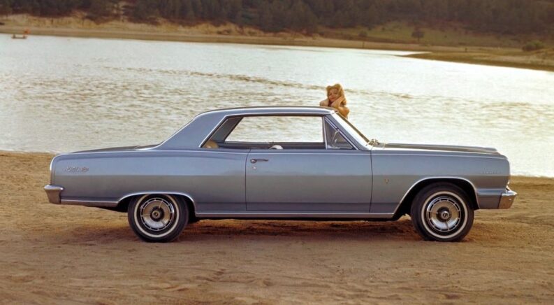A blue 1964 Chevy Chevelle Malibu SS is shown from the side after visiting a Chevy dealer.