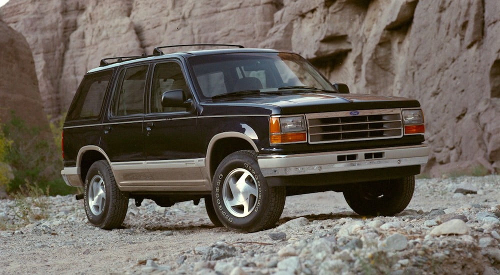 A green 1991 Ford Explorer is shown parked in rocky terrain.