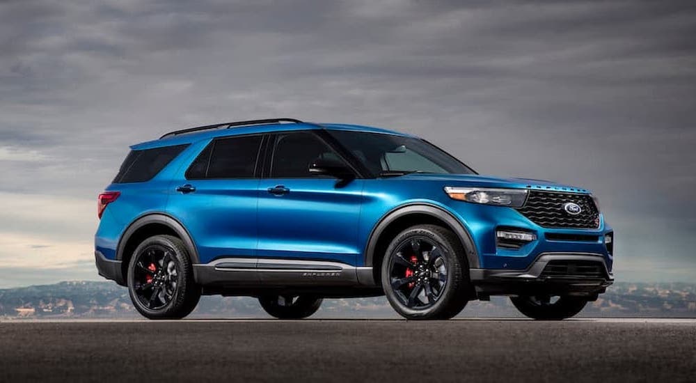 A blue 2020 Ford Explorer ST is shown parked under an overcast sky.