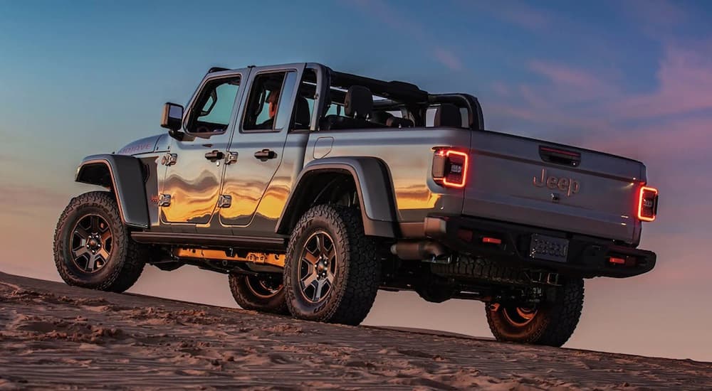 A grey 2023 Jeep Gladiator Mojave is shown from the rear at an angle after leaving a dealer that has a Jeep Gladiator for sale.