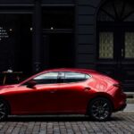 A red 2023 Mazda3 for sale is shown.