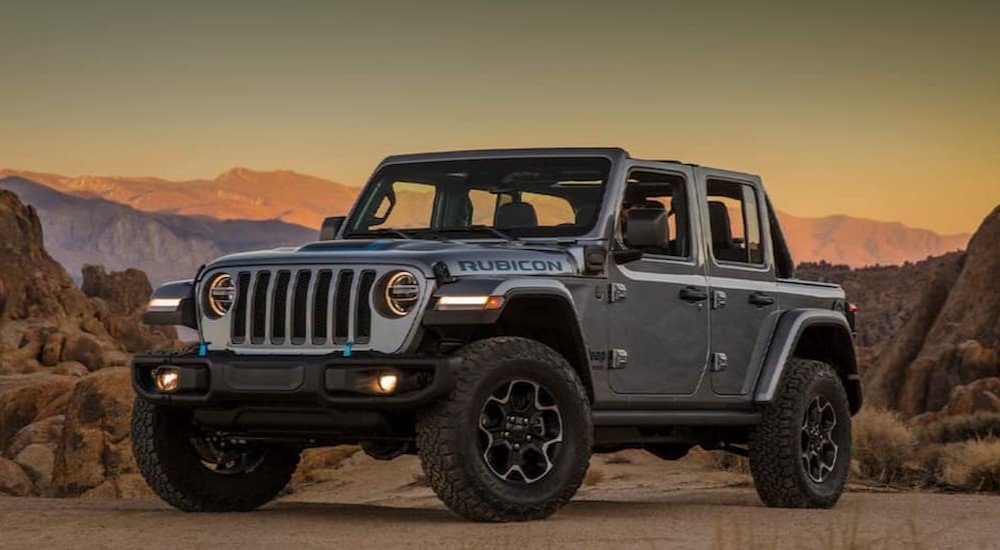 A gray 2021 Jeep Wrangler 4xe Rubicon is shown parked off road.