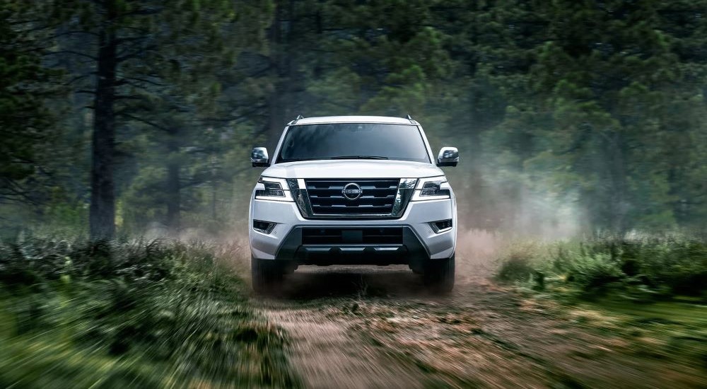 A white 2023 Nissan Armada is shown driving off-road.