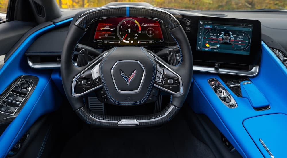 The blue and black interior and dash of a 2024 Chevy Corvette E-Ray is shown.