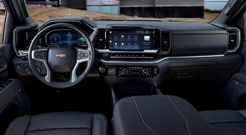 The black interior and dash of a 2024 Chevy Silverado 3500 HD, a popular Chevy Silverado for sale near Middleton, PA, is shown.