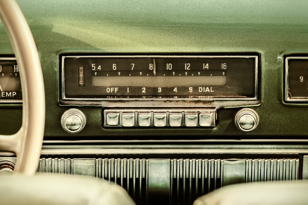 An older radio is shown inside of a vehicle.