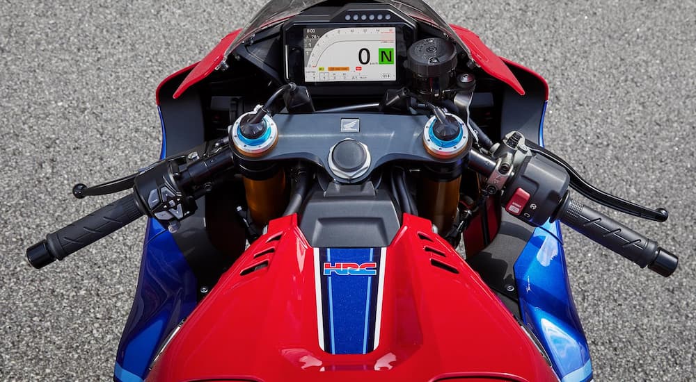 The rider's view of the 2021 Honda CBR1000RR-R Fireblade SP is shown with its full-color TFT and electronically-controlled Ohlins dampers.
