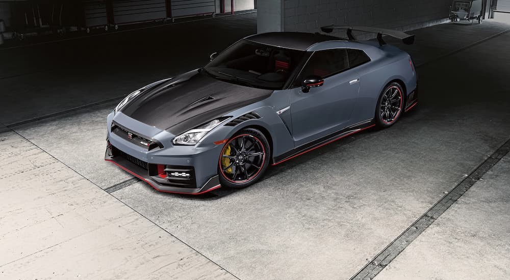 A black and blue 2024 Nissan GT-R NISMO is shown parked in a garage.