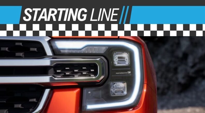The driver side headlight is shown on an orange Ford Ranger Raptor under a Starting Line banner.