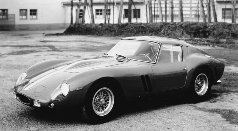 A 1962 Ferrari 250 GTO is shown parked.