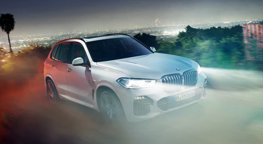 A white 2020 BMW X5 is shown from the front at an angle.