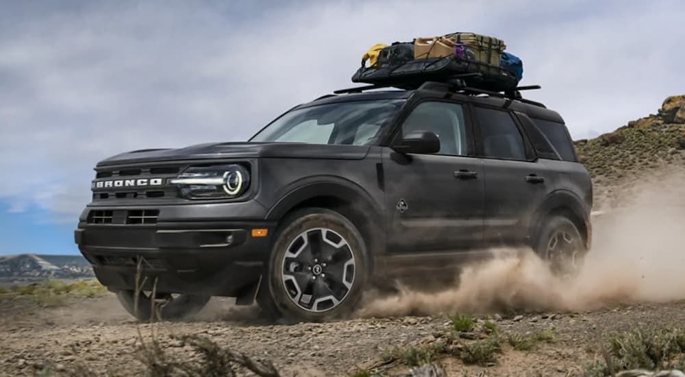 A black 2022 Ford Bronco Sport Big Bend is shown from the front at an angle while off-road after leaving a dealer that has a Ford Bronco Sport for sale.