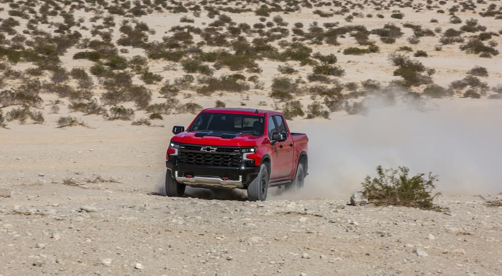 A red 2022 Chevy Silverado ZR2 is shown from the front at an angle after leaving a dealer that sells Chevy trucks.