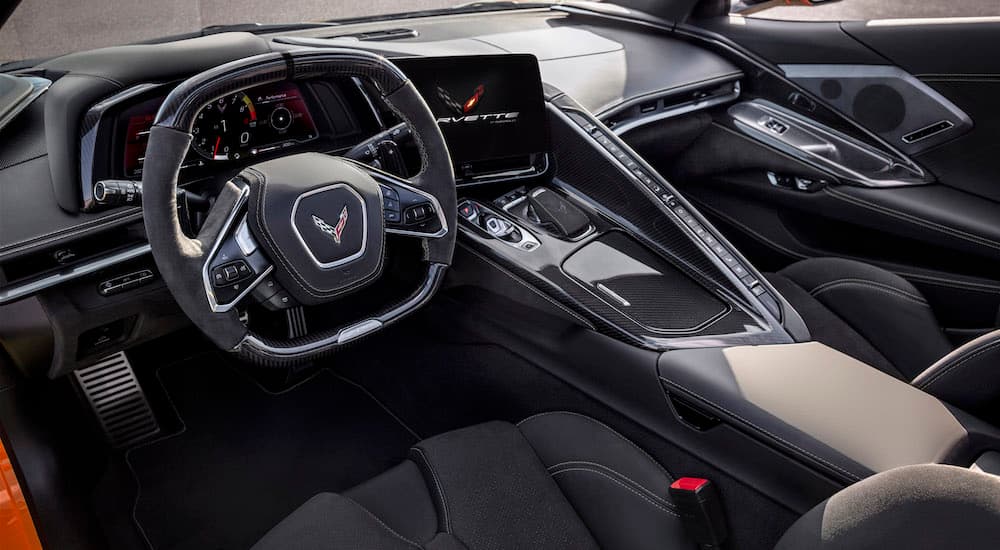 The black interior of a 2023 Chevy Corvette Z06 is shown from the driver's side door opening.