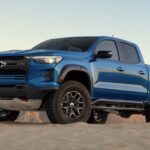 A blue 2023 Chevy Colorado ZR2 is shown from the side after winning a 2023 Chevy Colorado vs 2023 Nissan Frontier comparison.