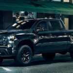 A black 2023 Chevy Silverado 1500 Midnight Edition is shown from the side after participating in a 2023 Chevy Silverado 1500 vs 2023 Ford F-150 comparison.