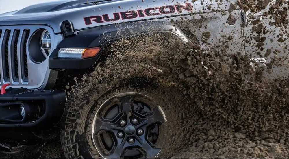 A gray 2023 Jeep Gladiator Rubicon is shown off-roading.