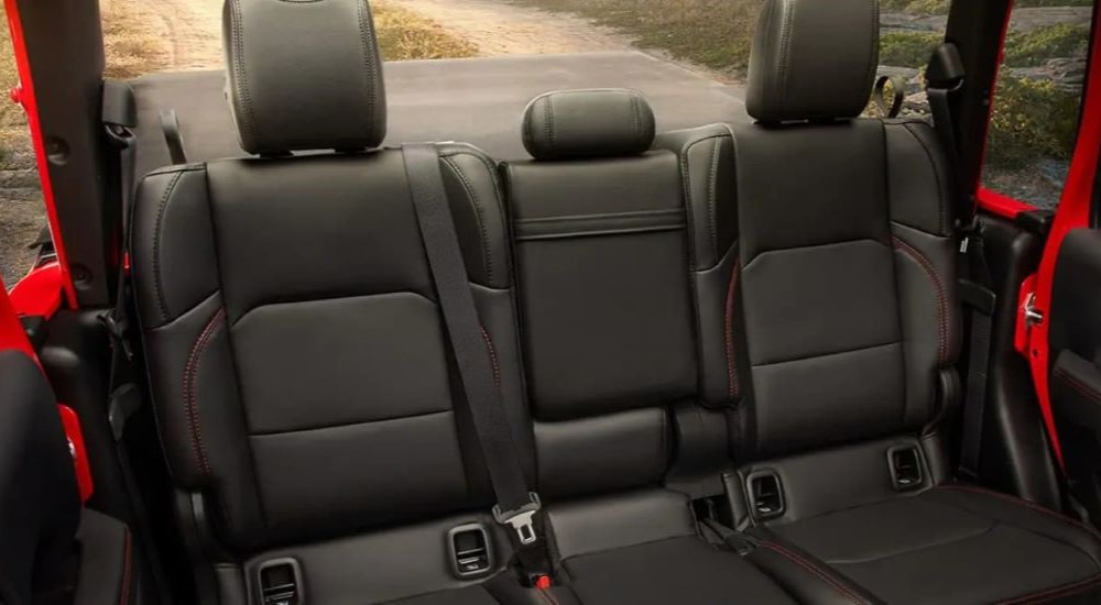 The black interior of a red 2023 Jeep Gladiator is shown.