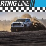 A white 2024 Chevy Colorado ZR2 Bison is shown from the front at an angle while kicking up dirt off-road.