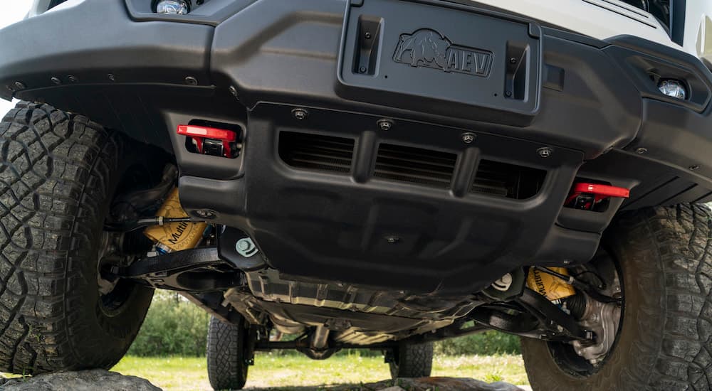 The undercarriage of a white 2024 Chevy Colorado ZR2 Bison is shown from the front in close up.