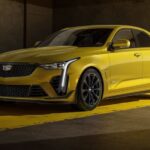 A yellow 2023 Cadillac CT4-V Blackwing is shown parked after visiting a Cadillac dealer.