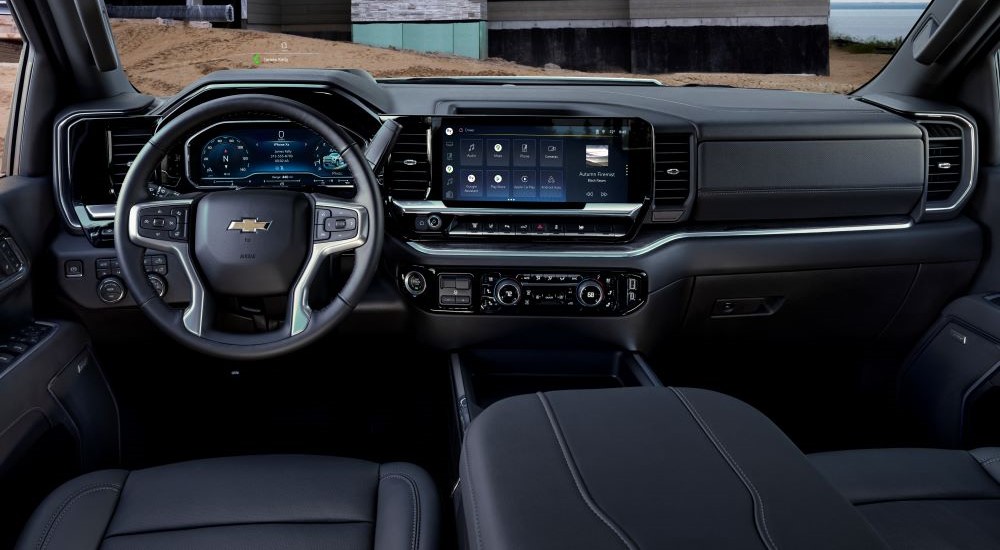 The black interior and dash of a 2024 Chevy Silverado 3500 HD is shown.