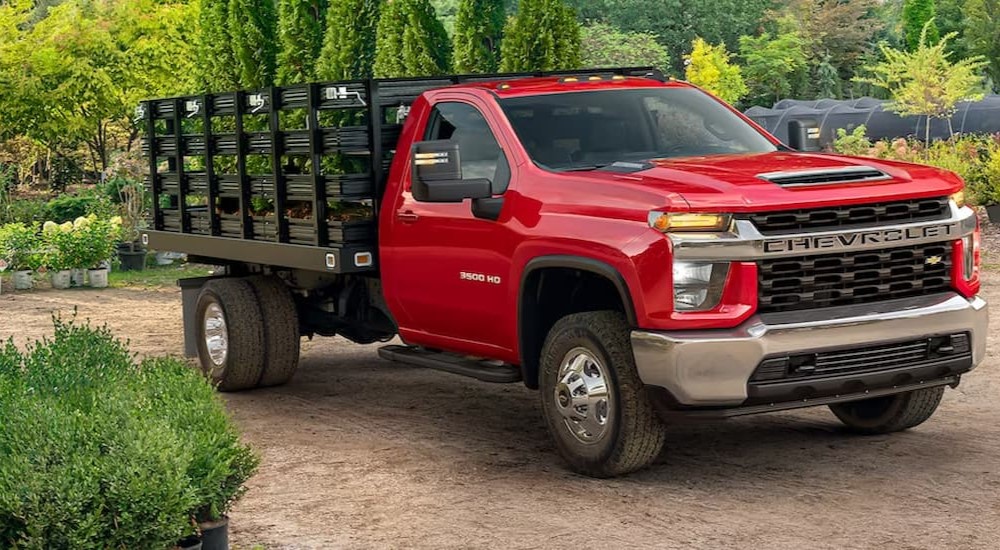 A red 2023 Chevy Silverado 3500 HD is shown parked.