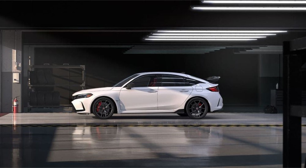 A white 2023 Honda Civic Type-R is shown parked in a garage.