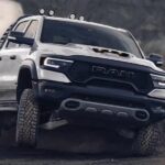 A white 2023 Ram 1500 TRX is shown off-roading.