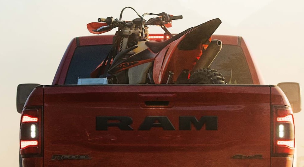 The rear of a red 2023 Ram 2500 Rebel 4x4 is shown.