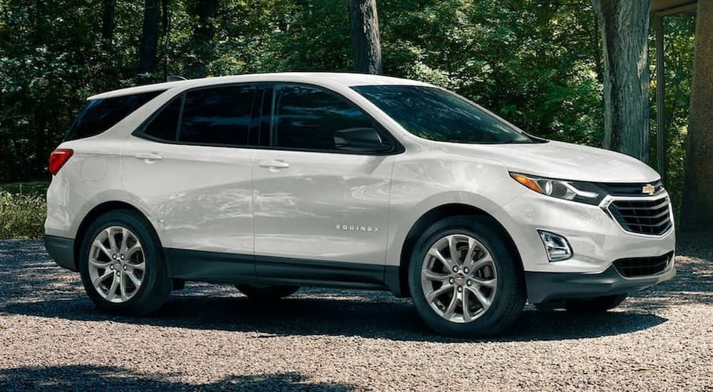 A white 2020 Chevy Equinox is shown parked on a dirt path.