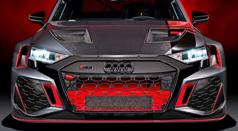 The black and red 2021 Audi RS 3 LMS is shown from the front.