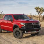 A red 2022 Chevy Silverado 1500 ZR2 is shown from the front at an angle after leaving a dealer that has a for spirited drivers looking for the right pickup truck, you'll want to look for a Chevy Silverado for sale near you.