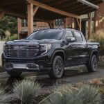 A black 2022 GMC Sierra 1500 Denali Ultimate is shown from the front at an angle.