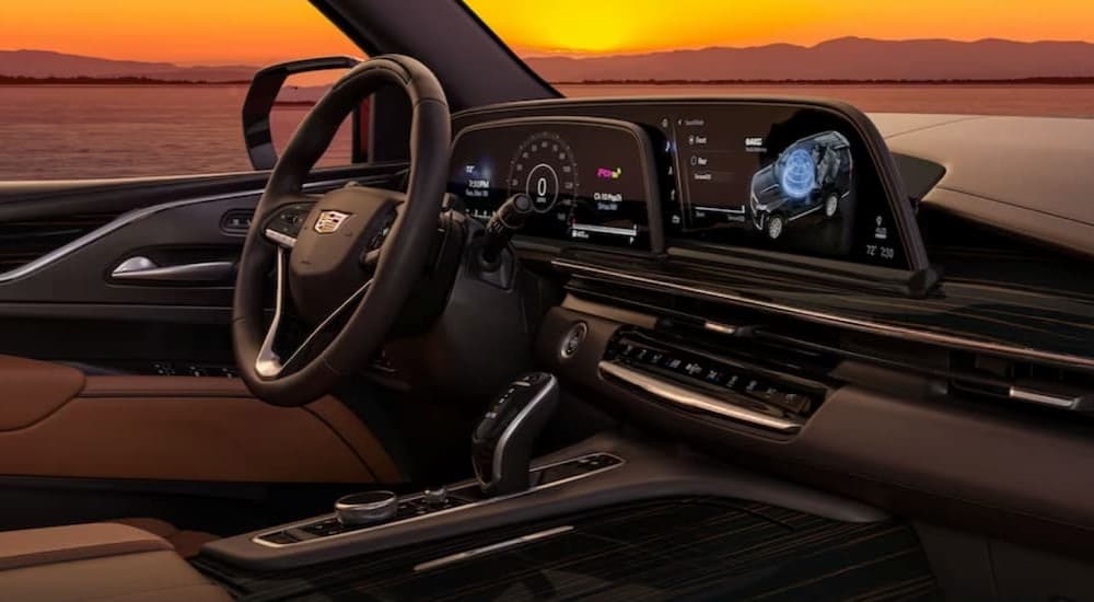 The black and brown interior and dash of a 2023 Cadillac Escalade is shown.