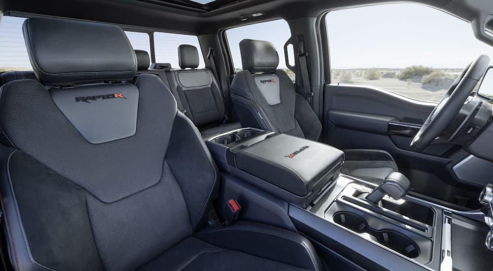 The black interior of a 2023 Ford F-150 Raptor R is shown from the passenger side.