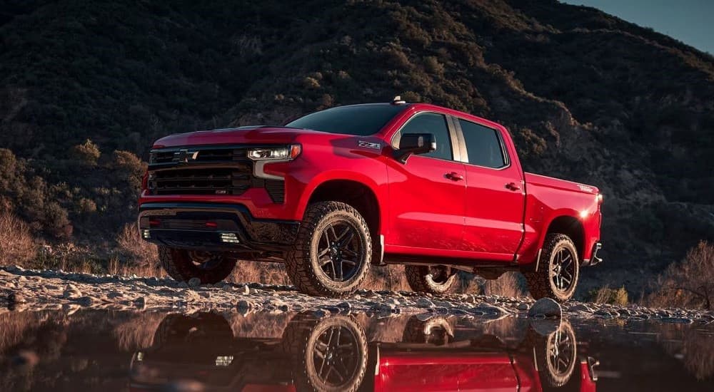 A red 2023 Chevy Silverado 1500 Z71 Trail Boss is shown parked off-road.