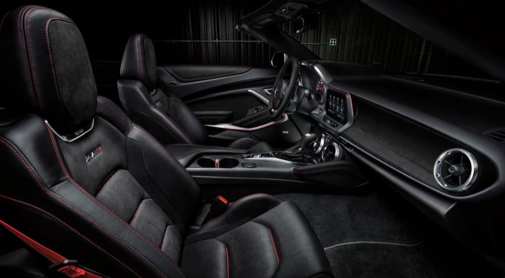 The black and red interior and dash of a 2024 Chevy Camaro ZL1 is shown.