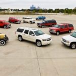 A collection of nine Chevy Suburban's is shown at a Chevy dealer.