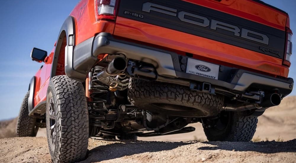A 5-link rear suspension with a Panhard rod is shown on a red 2023 Ford F-150 Raptor R.