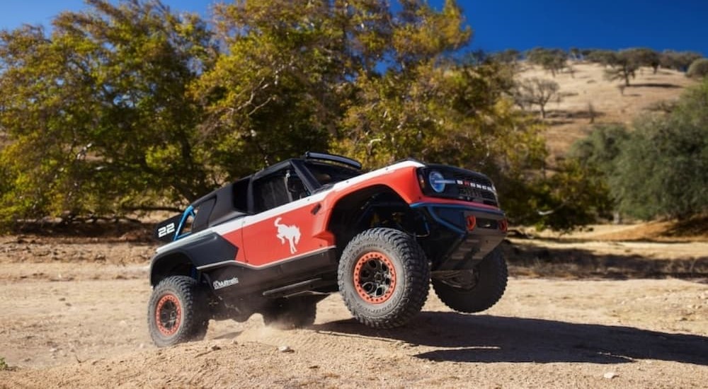A red and black 2023 Ford Bronco DR is shown off-roading.