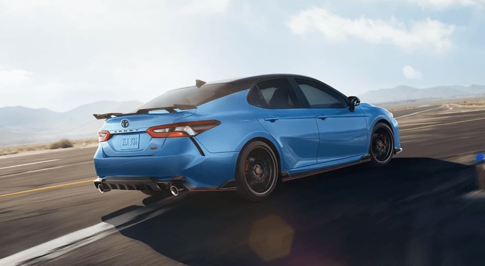 A blue 2023 Toyota Camry TRD is shown on a track after looking at a Toyota Camry for sale.